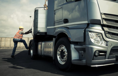 Truck driver working on truck Truck driver working on truck
