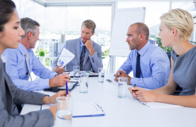 Business people speaking together during meeting in the office Business people speaking together during meeting in the office