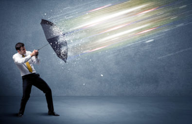 Business man defending light beams with umbrella concept on back Business man defending light beams with umbrella concept on back