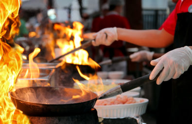 Professional Chef In A Commercial Kitchen Cooking Flambe Style Professional Chef In A Commercial Kitchen Cooking Flambe Style