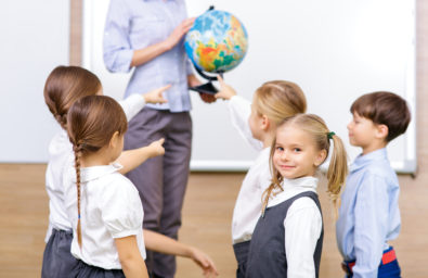 Group of children and teacher holding a globe. Group of children and teacher holding a globe.